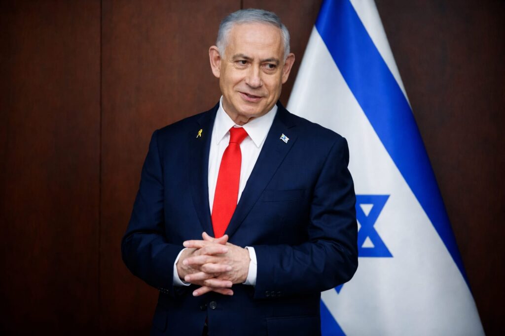 Israeli Prime Minister Benjamin Netanyahu speaking in front of Israel flag