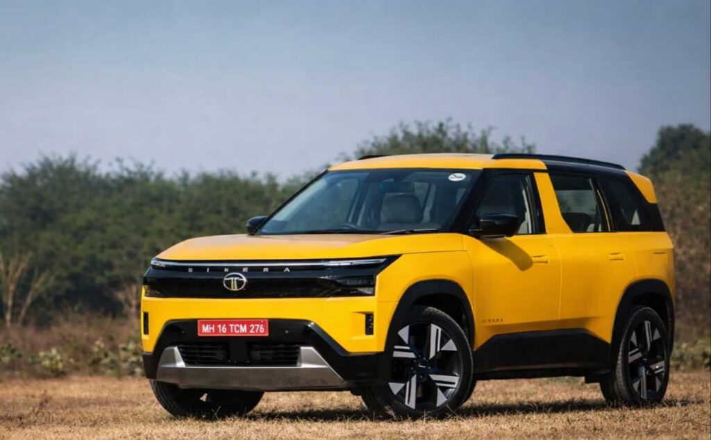 Tata Sierra 2026 yellow SUV front view in open field HD image